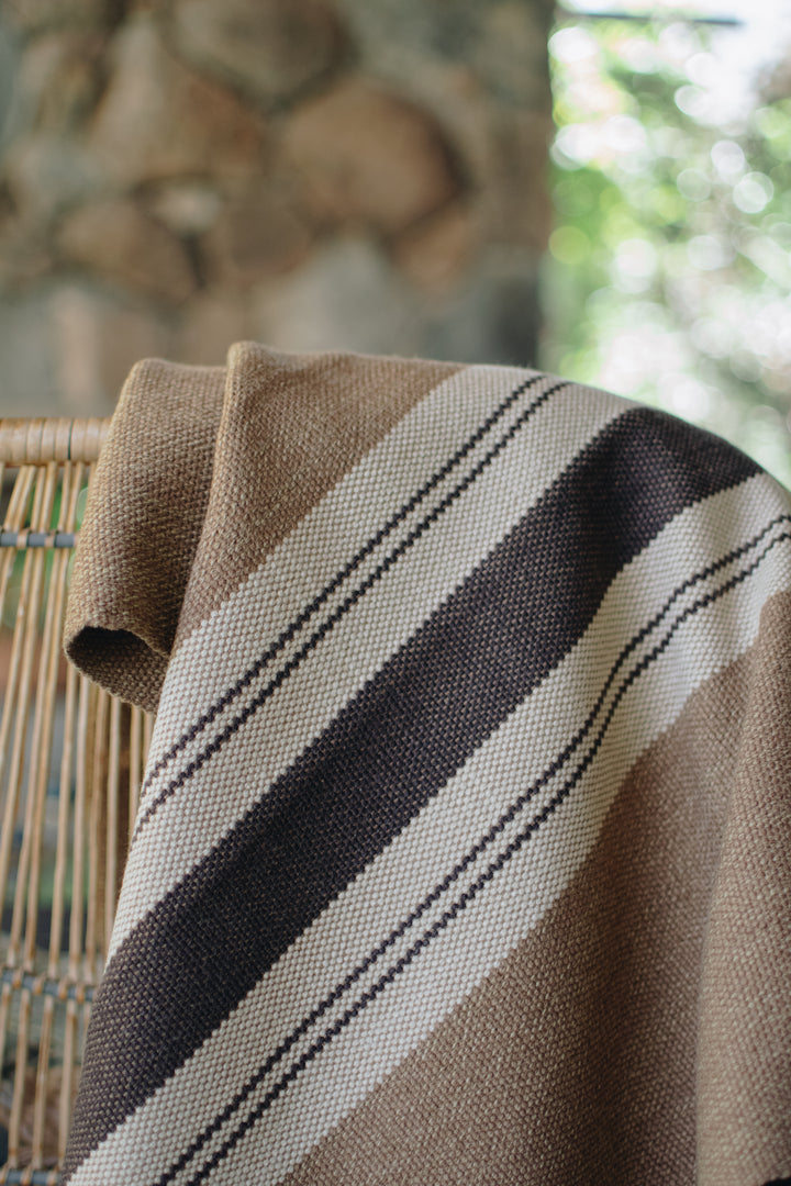 Light brown poncho with three stripes