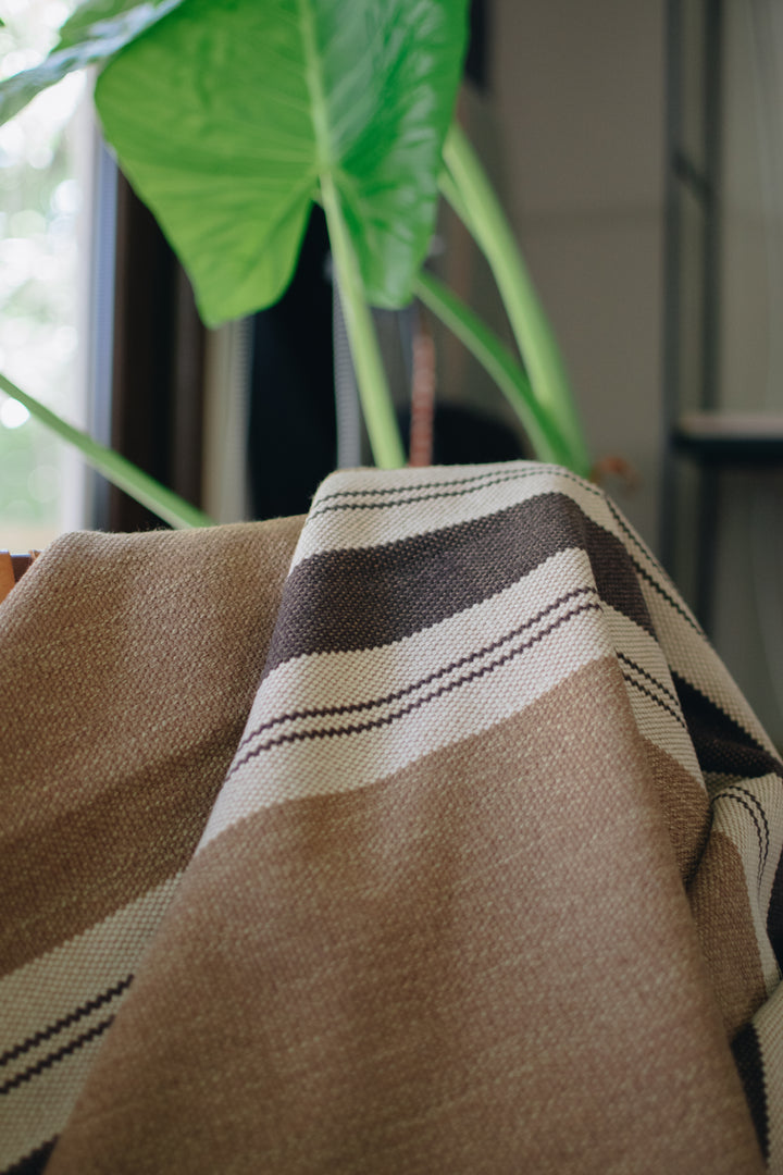 Light brown poncho with three stripes