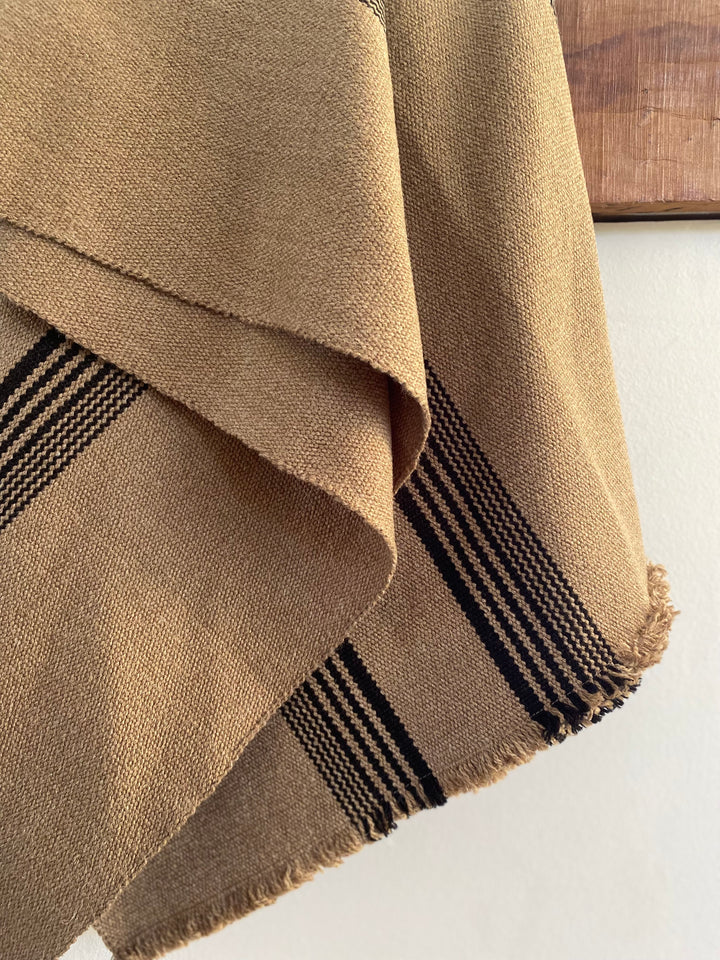 Light brown poncho with three stripes