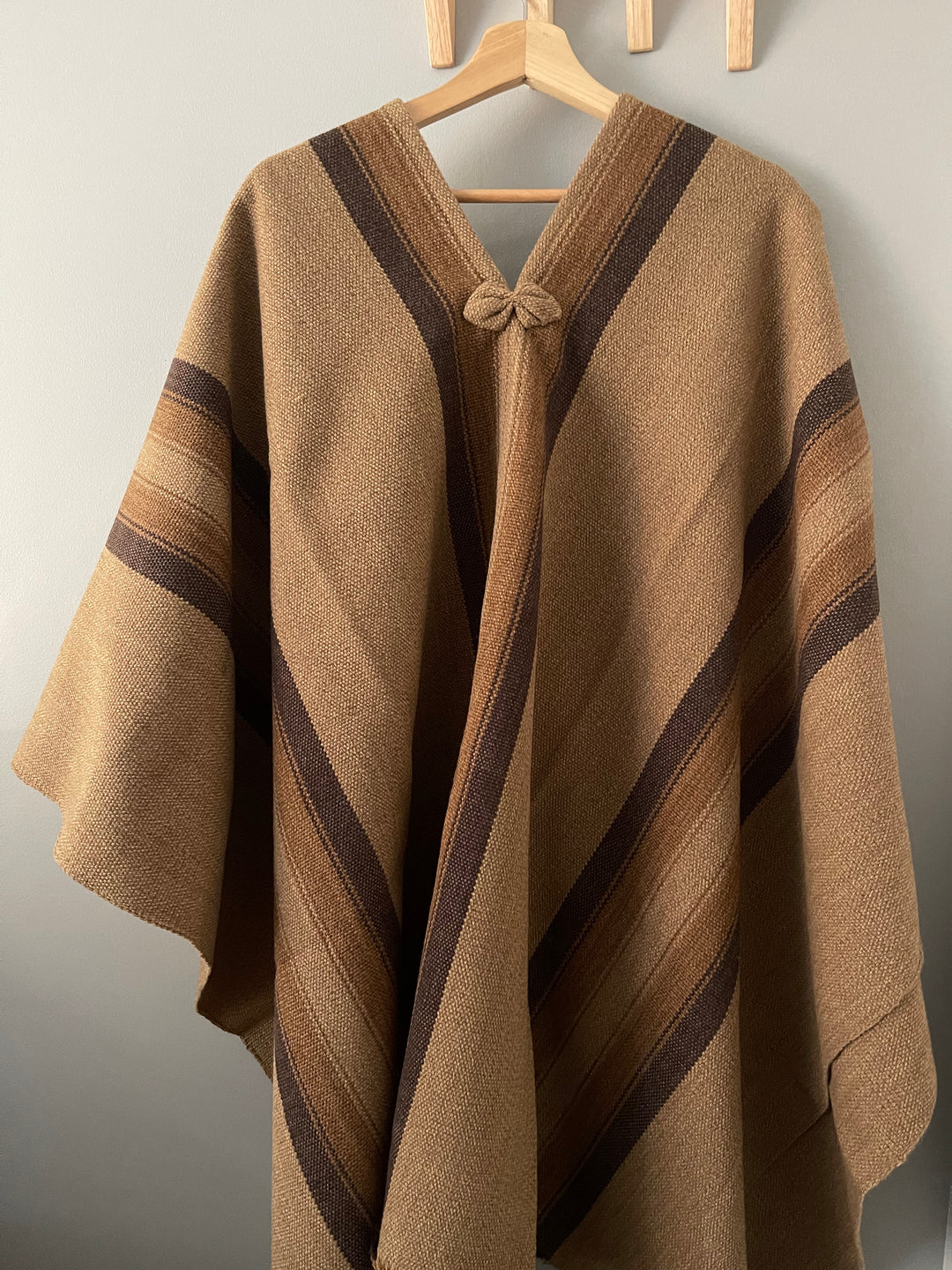 Light brown poncho with three stripes